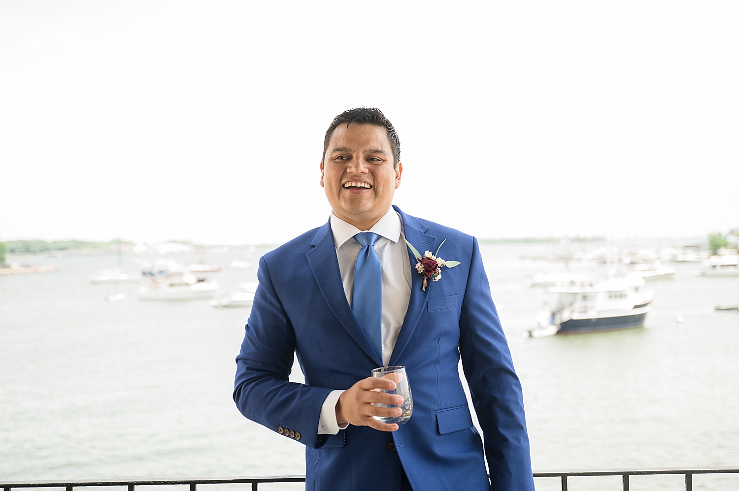 groom portrait on the water