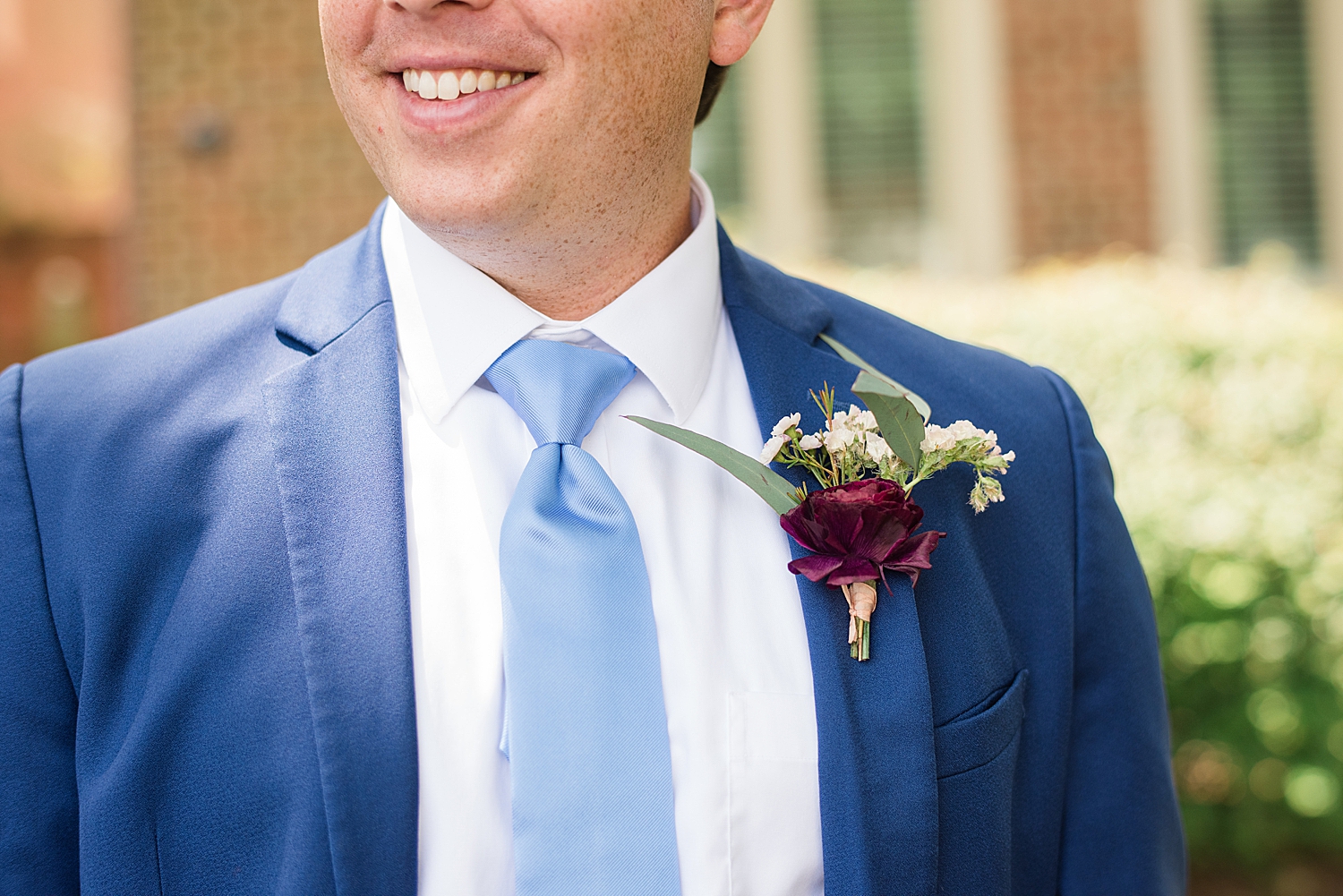 groom detail shot, plum boutonnière 