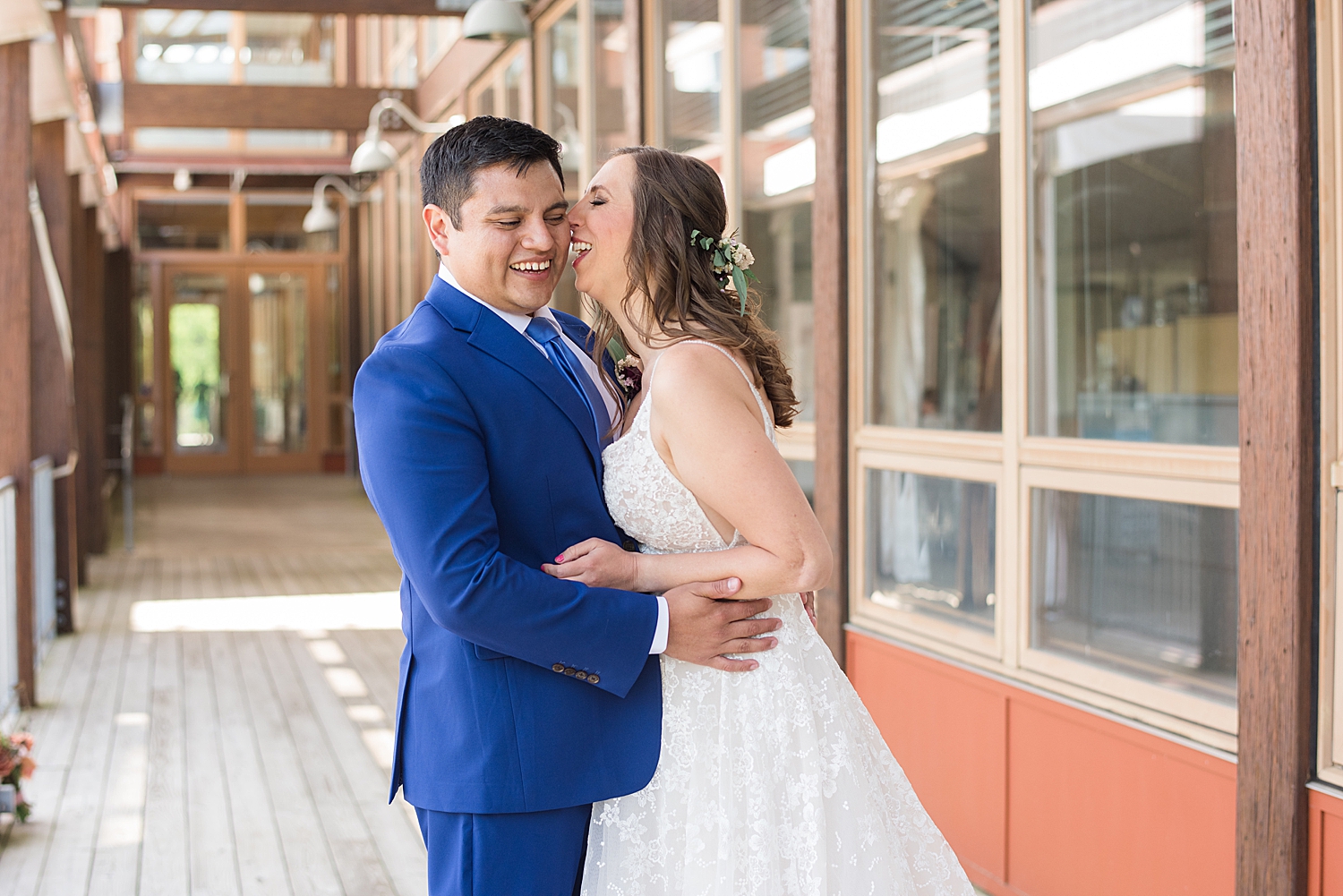 bride kisses groom on cheek