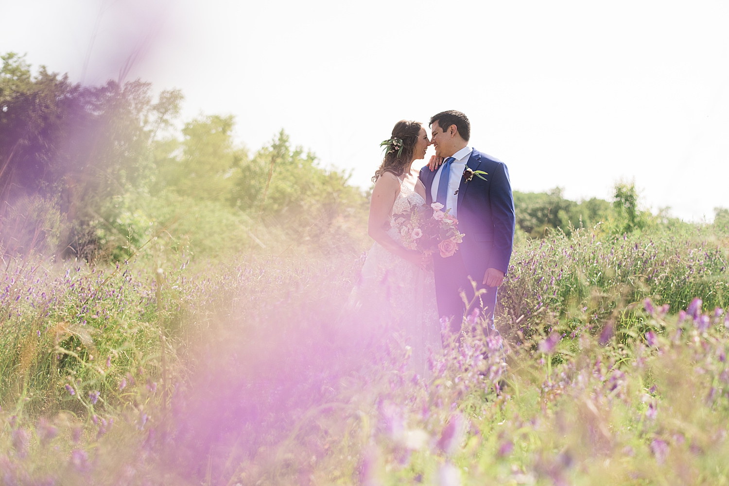 bride and groom portrait through flowers