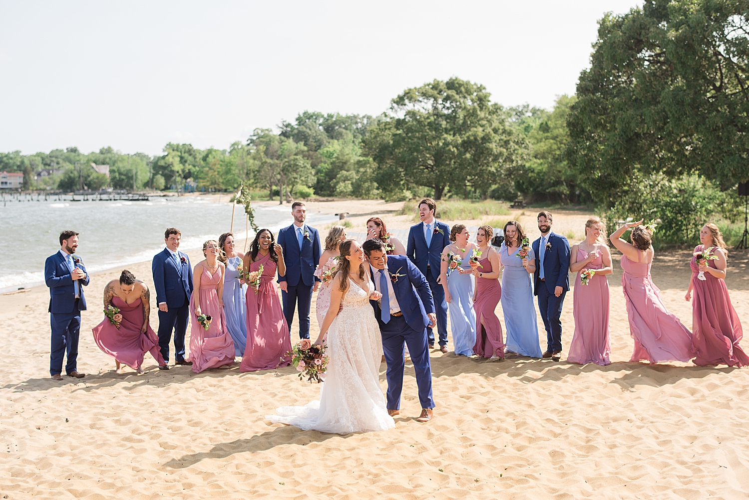 wedding party cheering while couple kiss