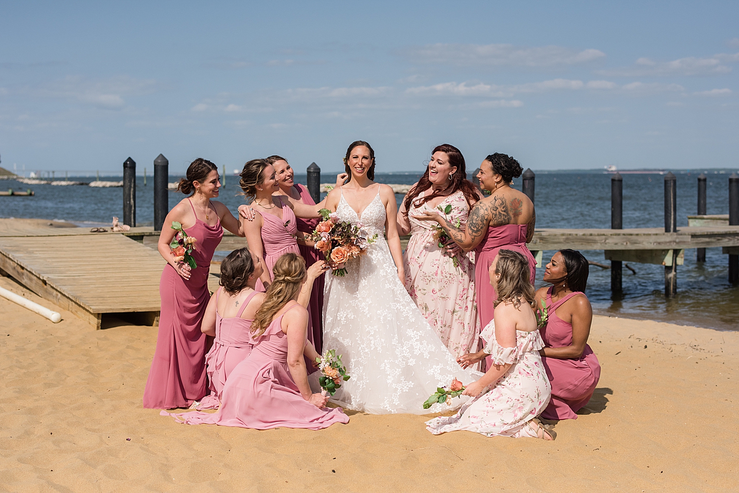 bridesmaids fixing bride on beach