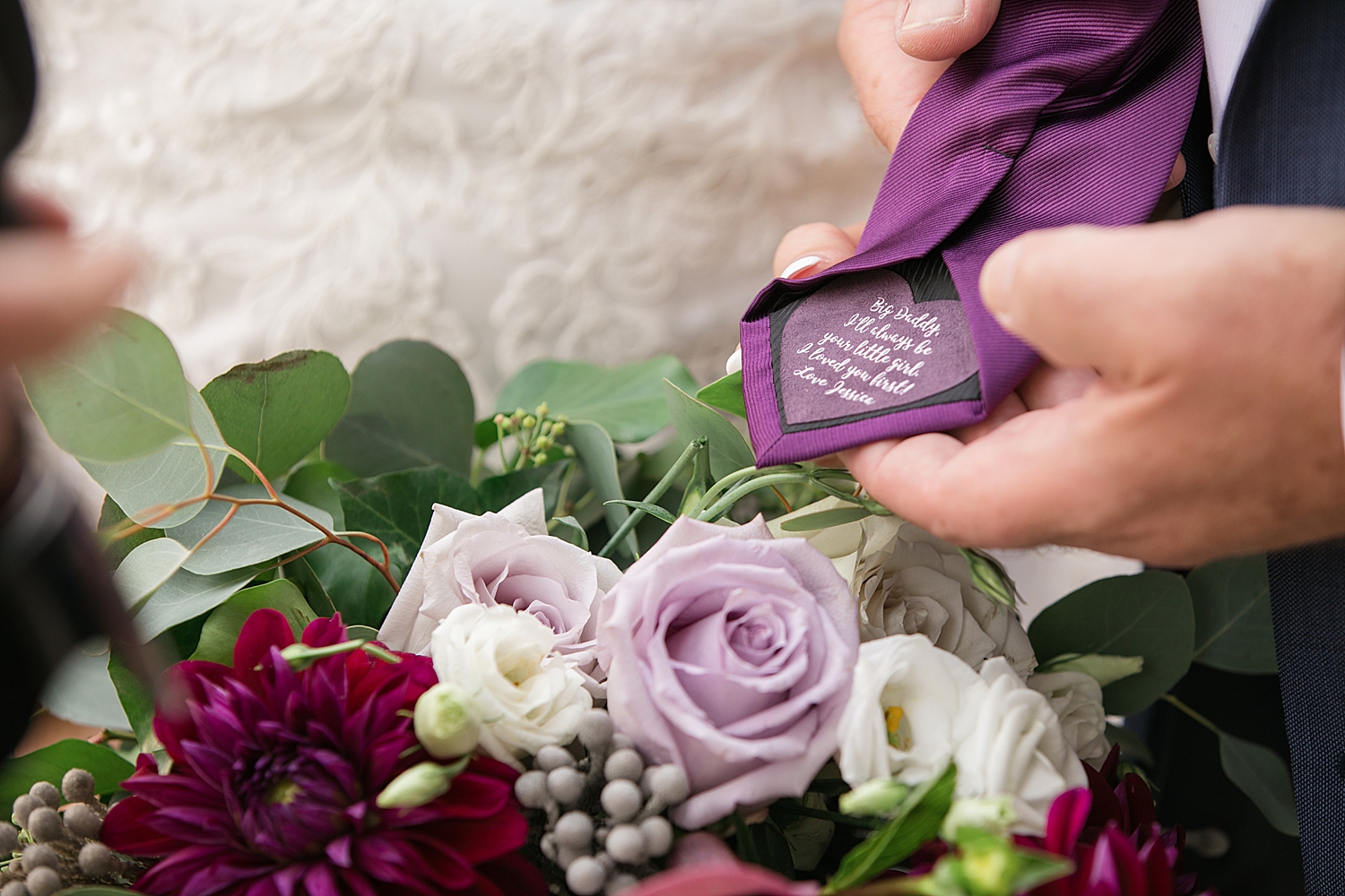 detail of purple bouquet and father of the bride's custom tie