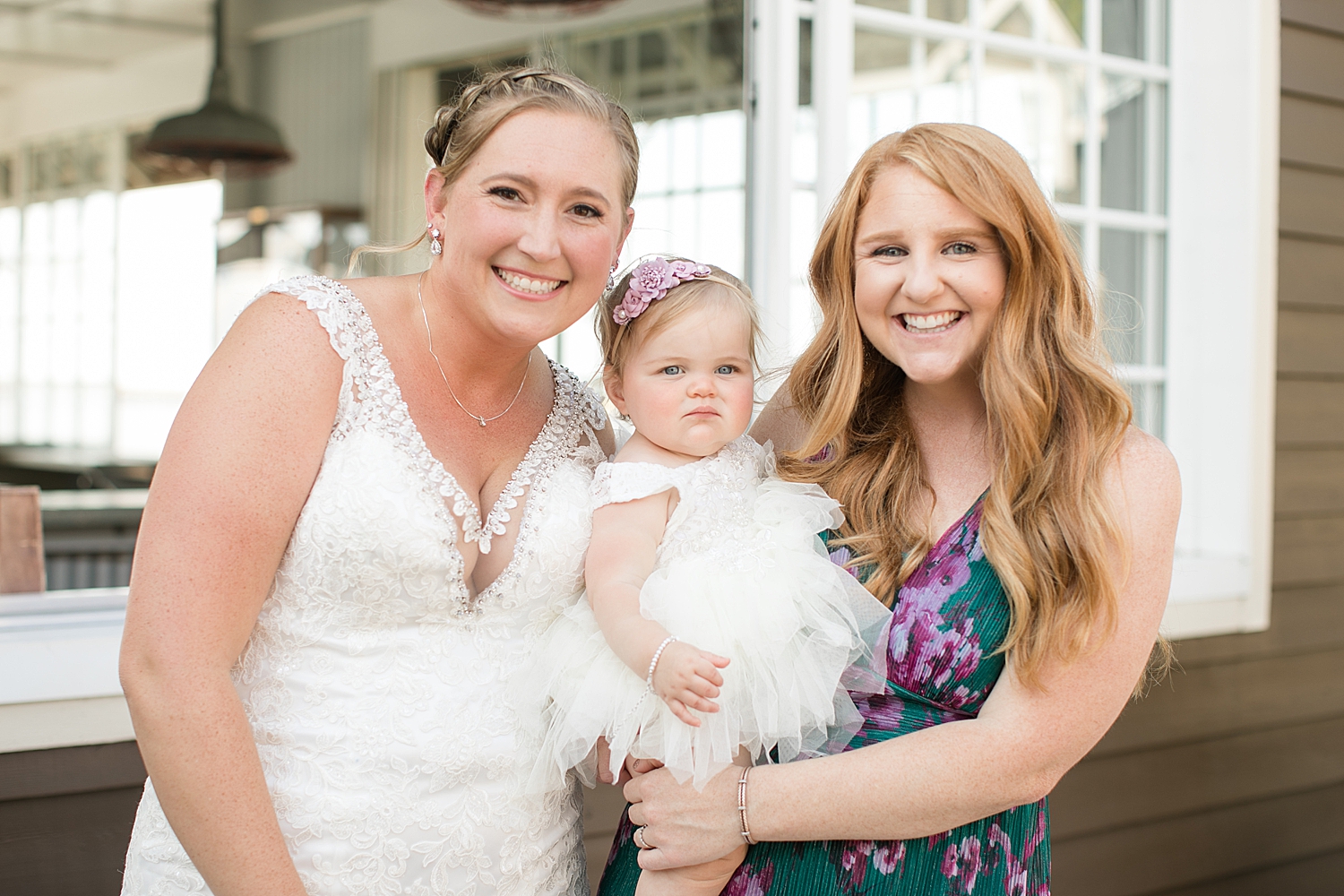 bride smiles with flower girl