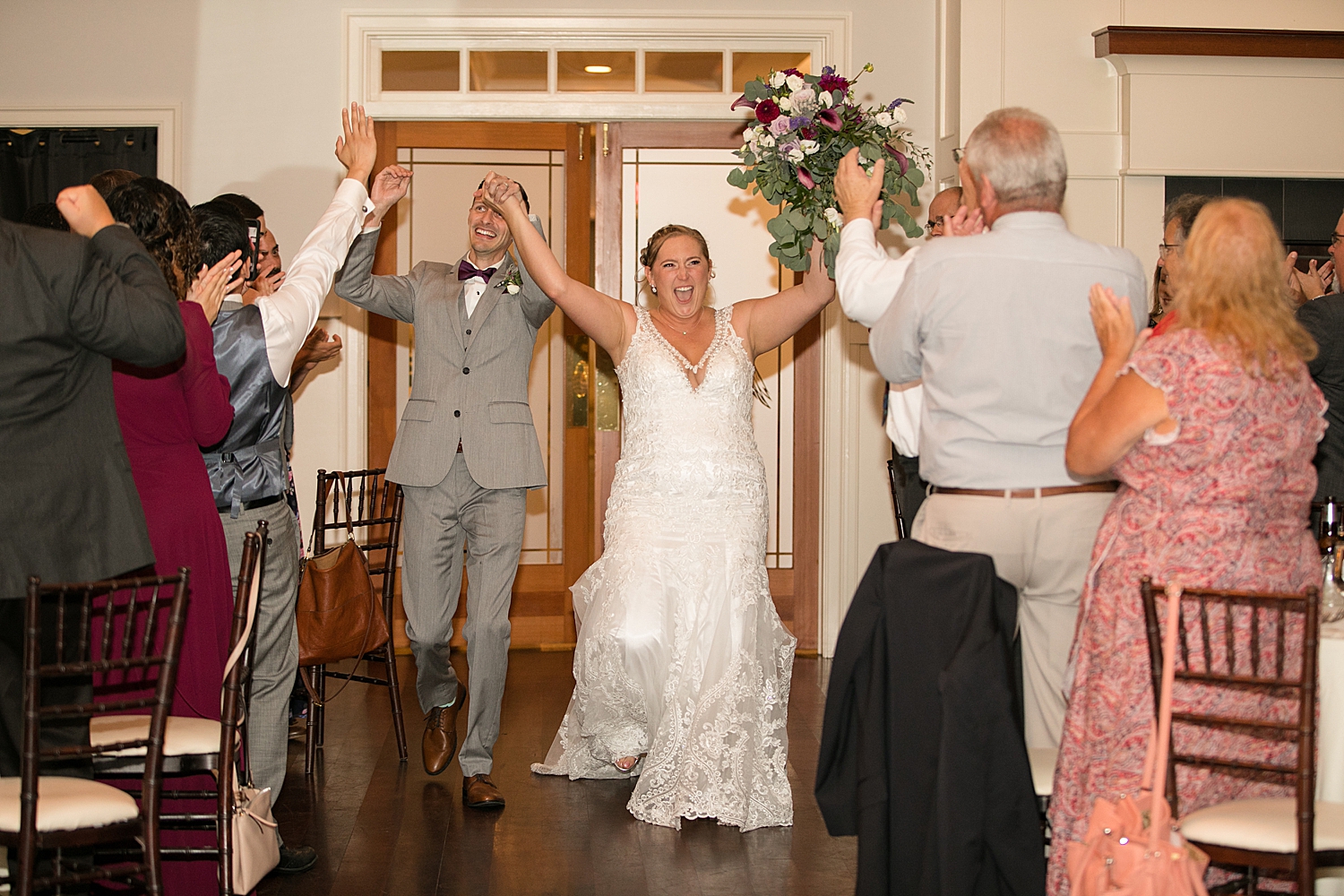 bride and groom enthusiastically enter reception