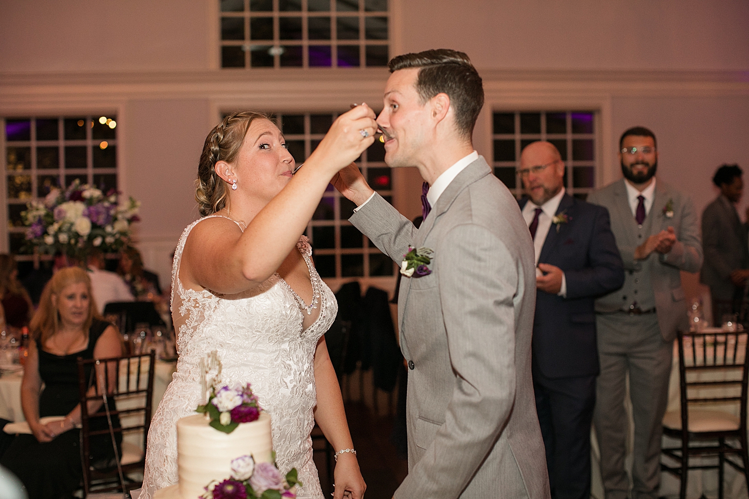 bride and groom feed each other cake