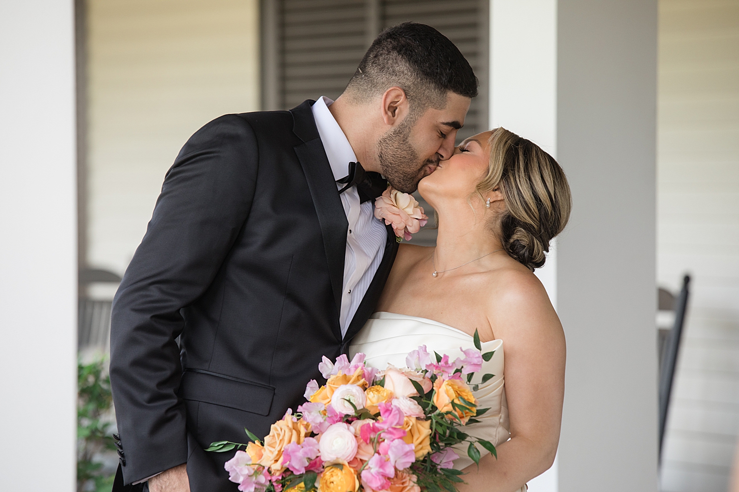 bride and groom kiss after first look