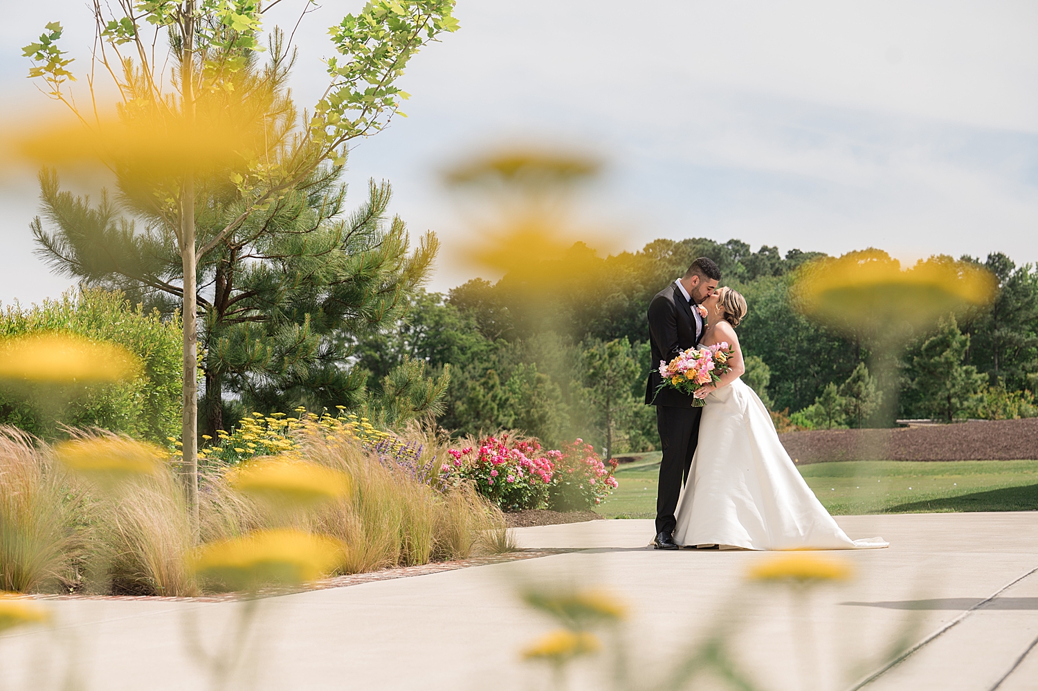 bride and groom couple portrait through flowers