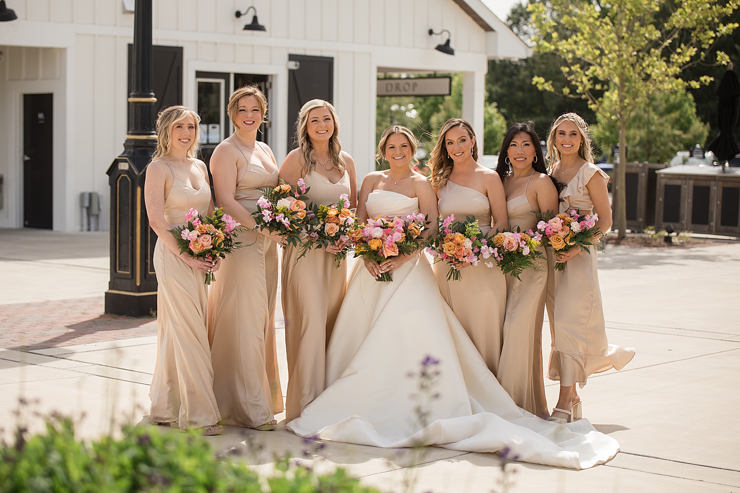 bride with bridesmaids in champagne gowns