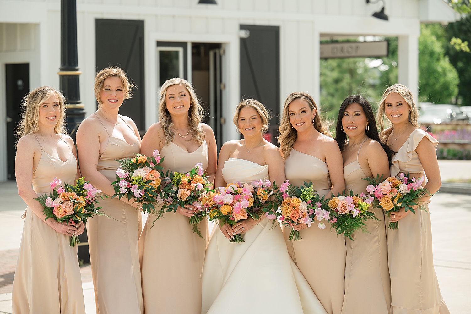 bride with bridesmaids in champagne gowns