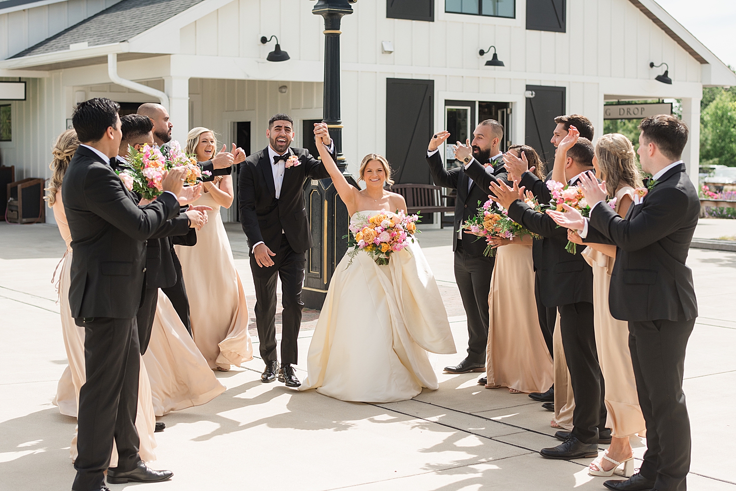 bride and groom wedding party tunnel cheer