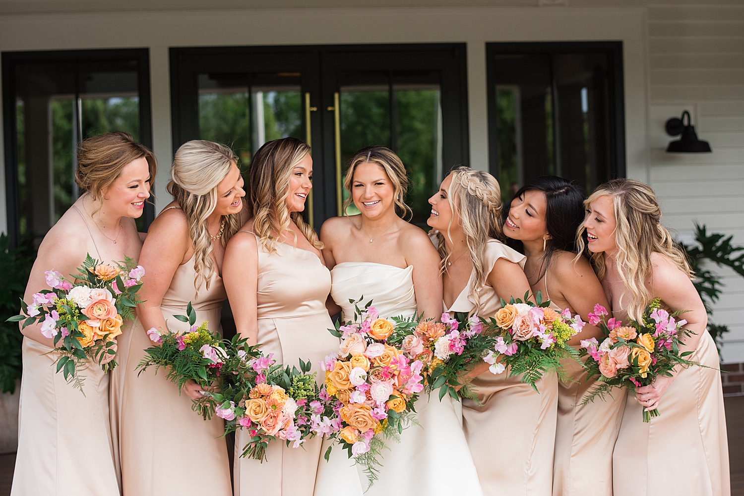 bridesmaids looking at bride, smiling