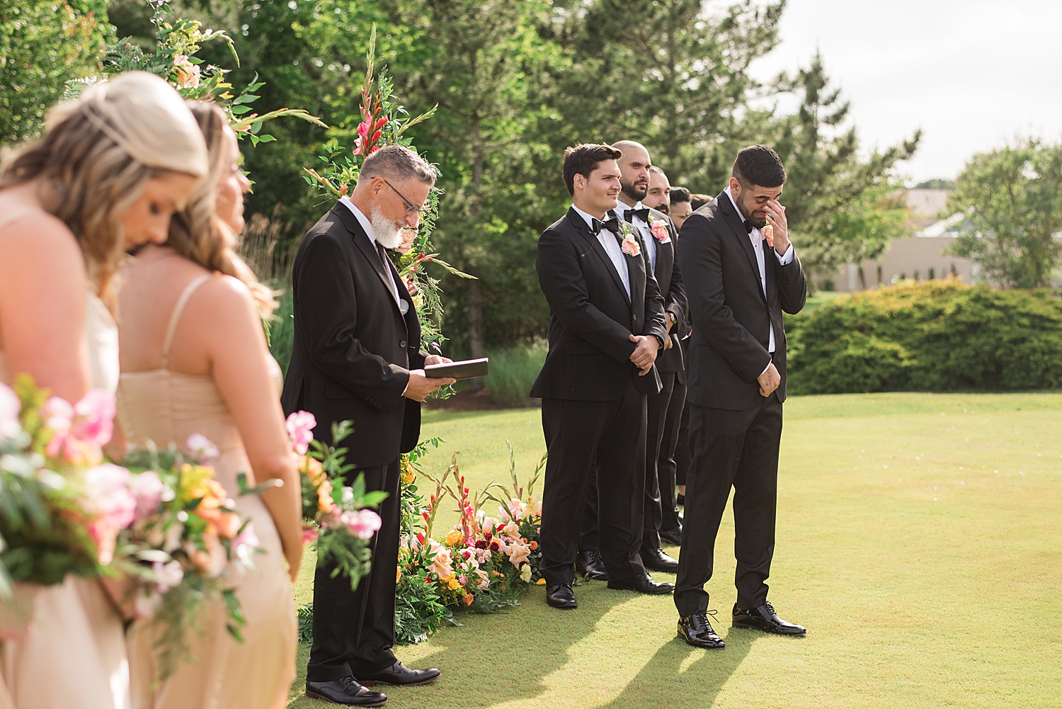 groom waiting for bride at the end of the aisle