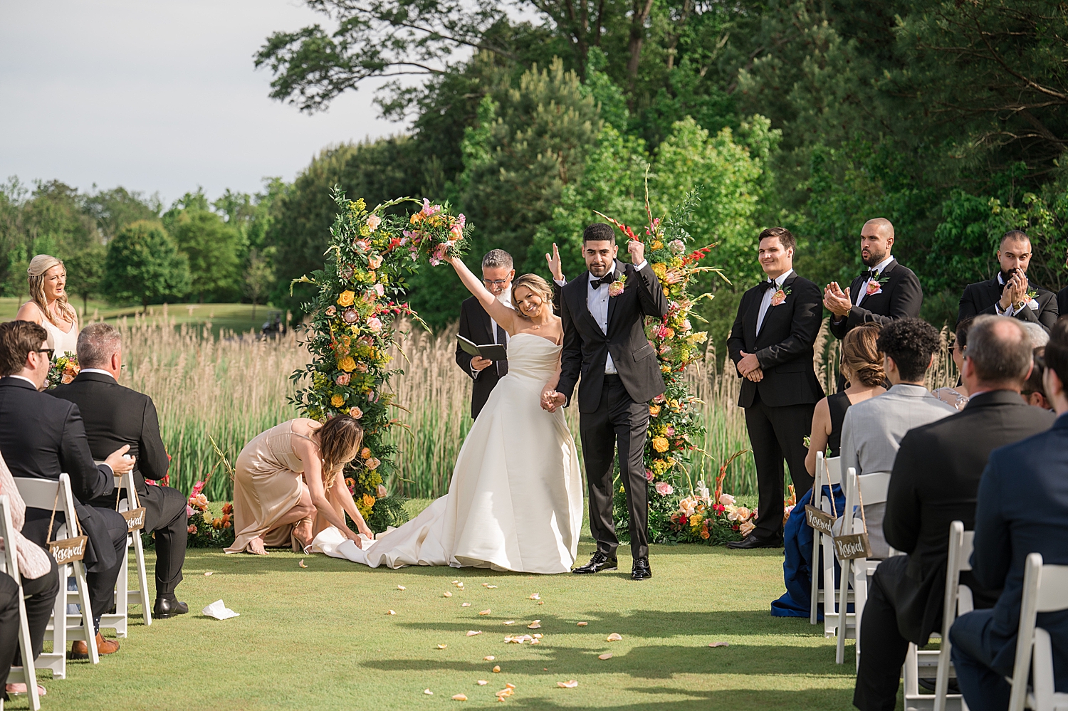 bride and groom cheer after ceremony