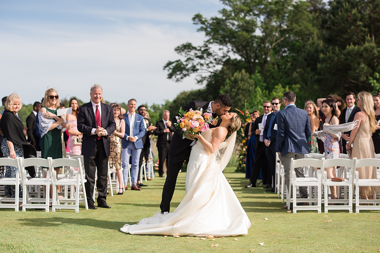 bride and groom kiss as they exit ceremony