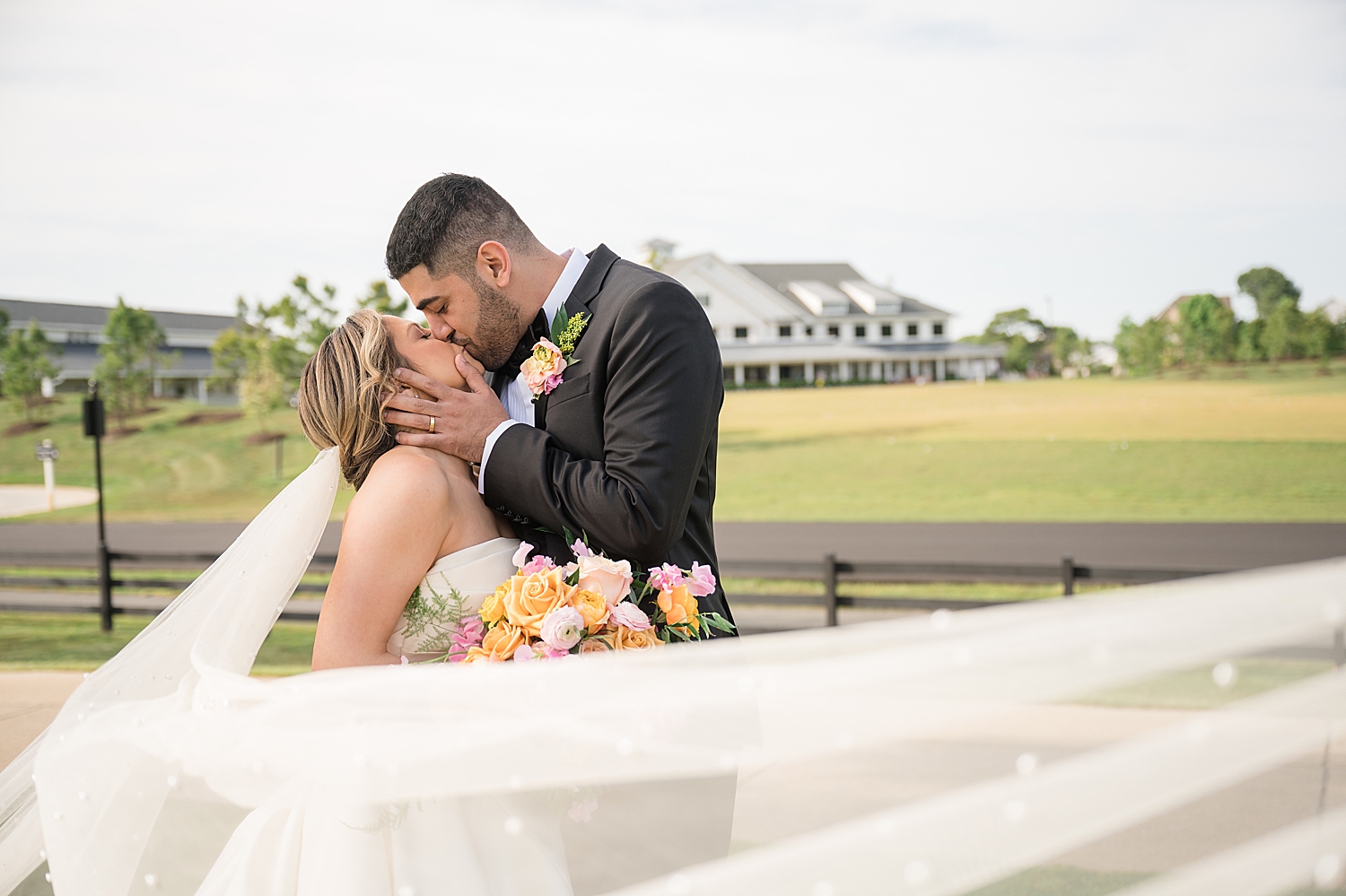 shooting wedding couple portrait through veil, kiss