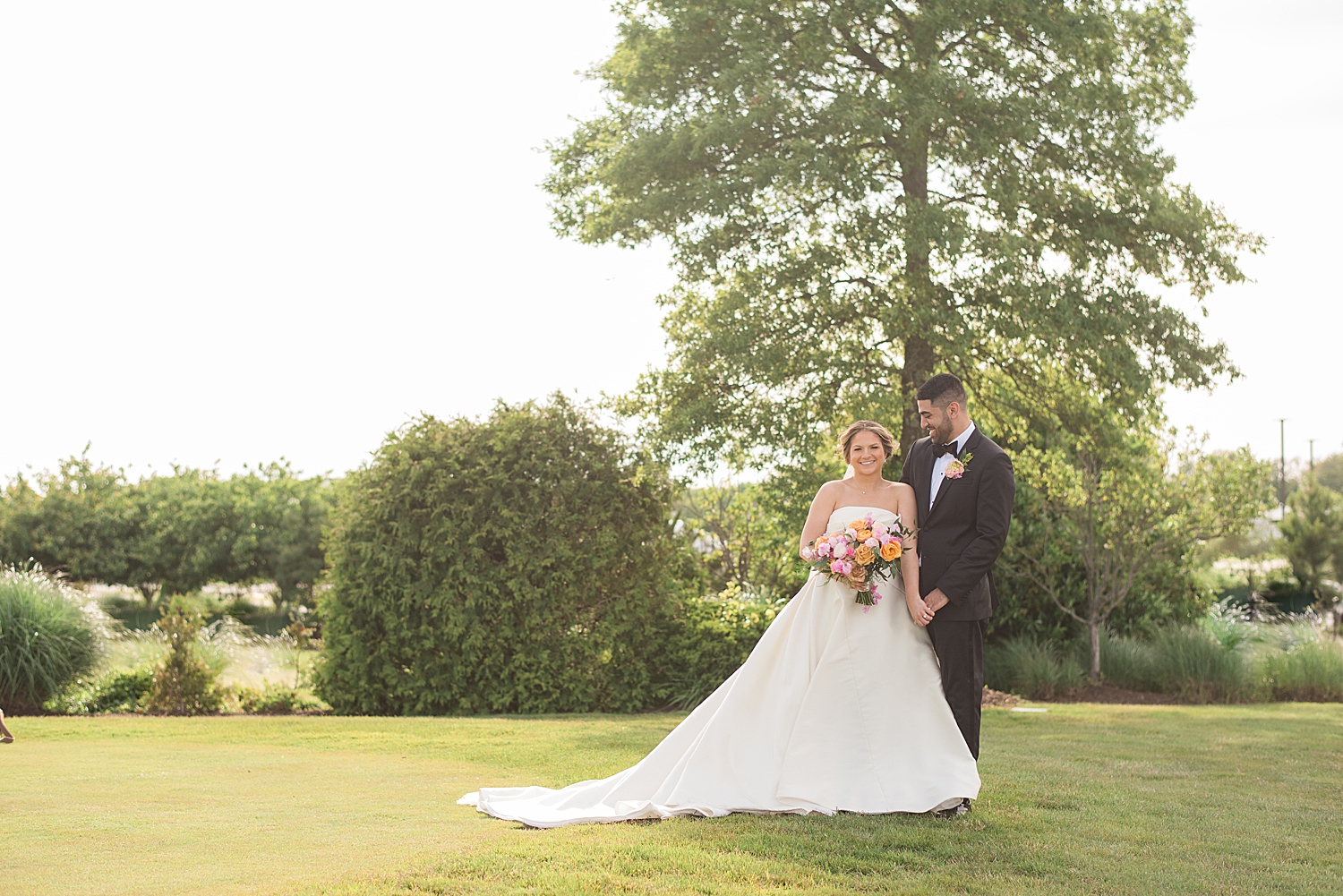 bride and groom couple portrait in grass