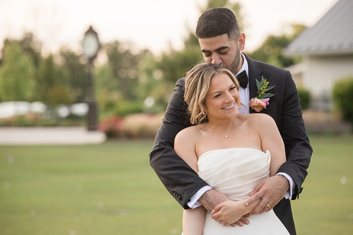 groom embracing bride, kissing head