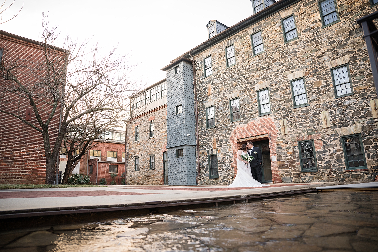 bride and groom portrait in front of mt washington mill dye house venue