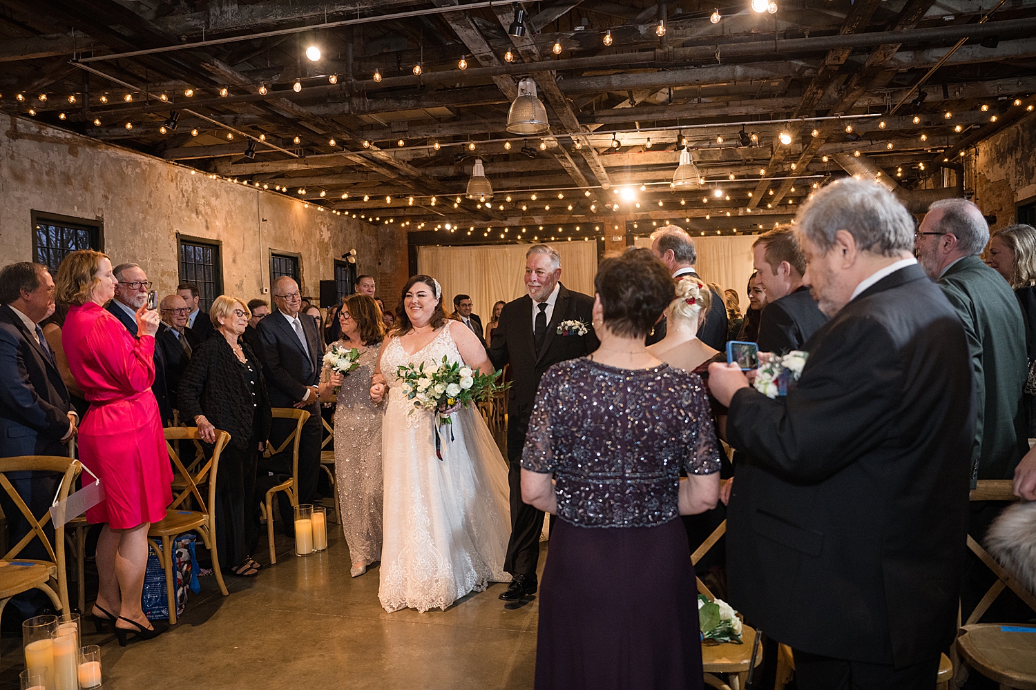 bride approaches ceremony with parents