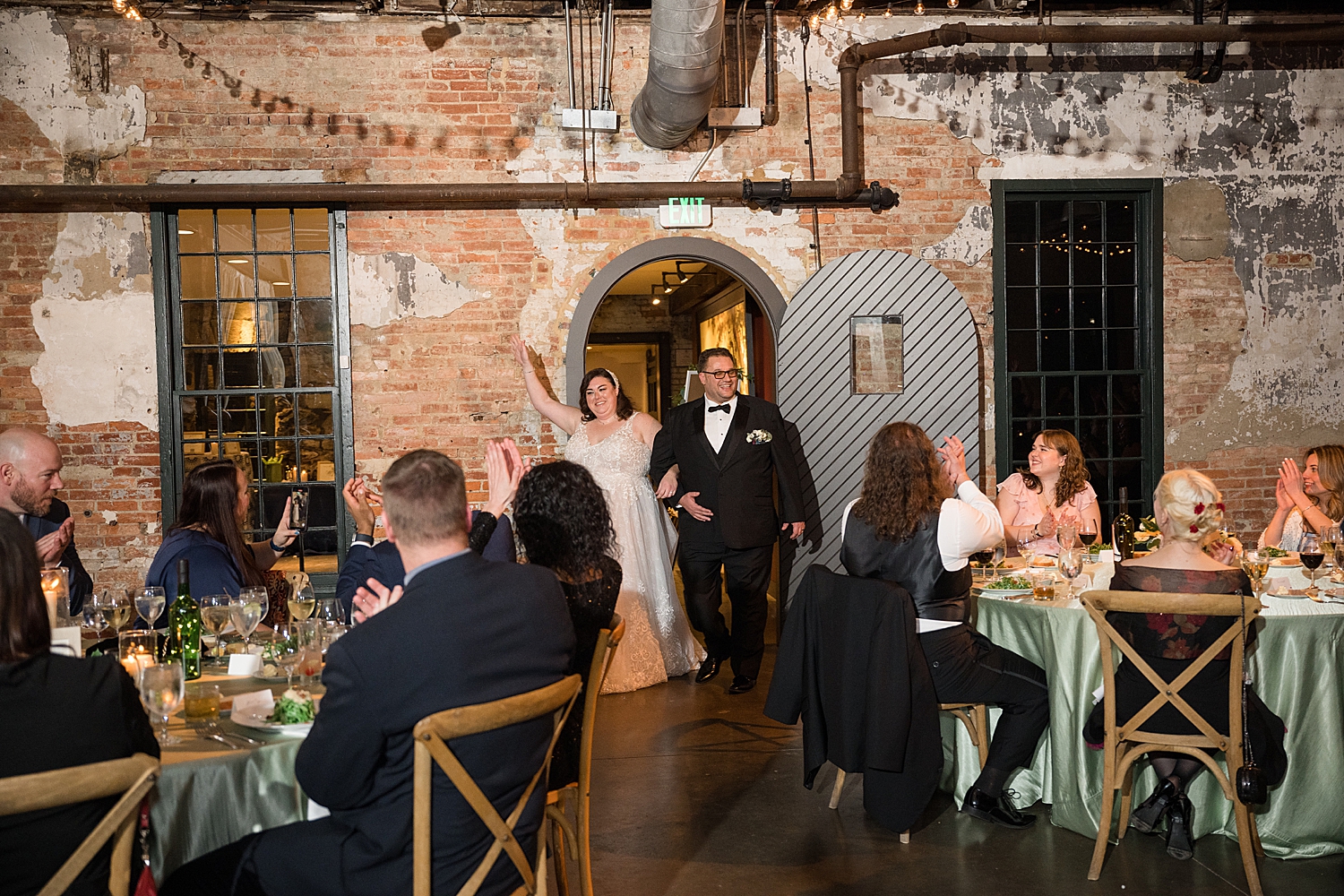 bride and groom entering reception