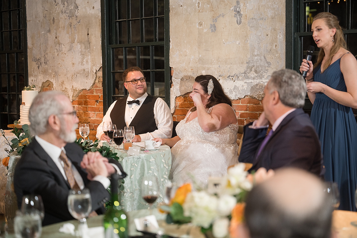 bride and groom listening and reacting to toasts