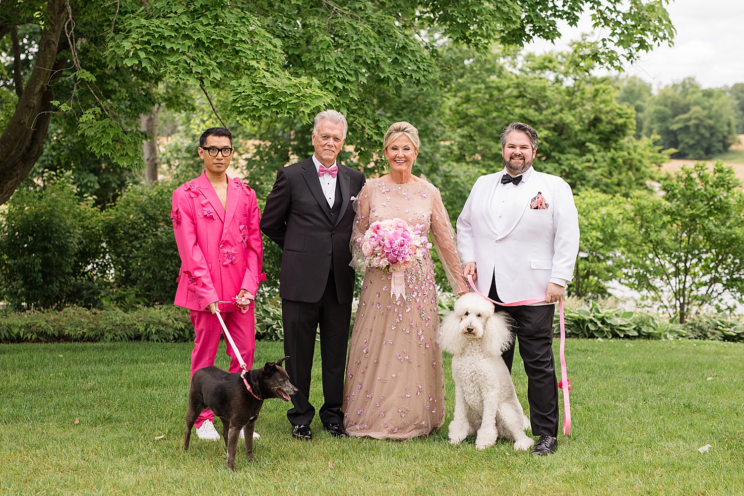 bride and groom with family and dogs