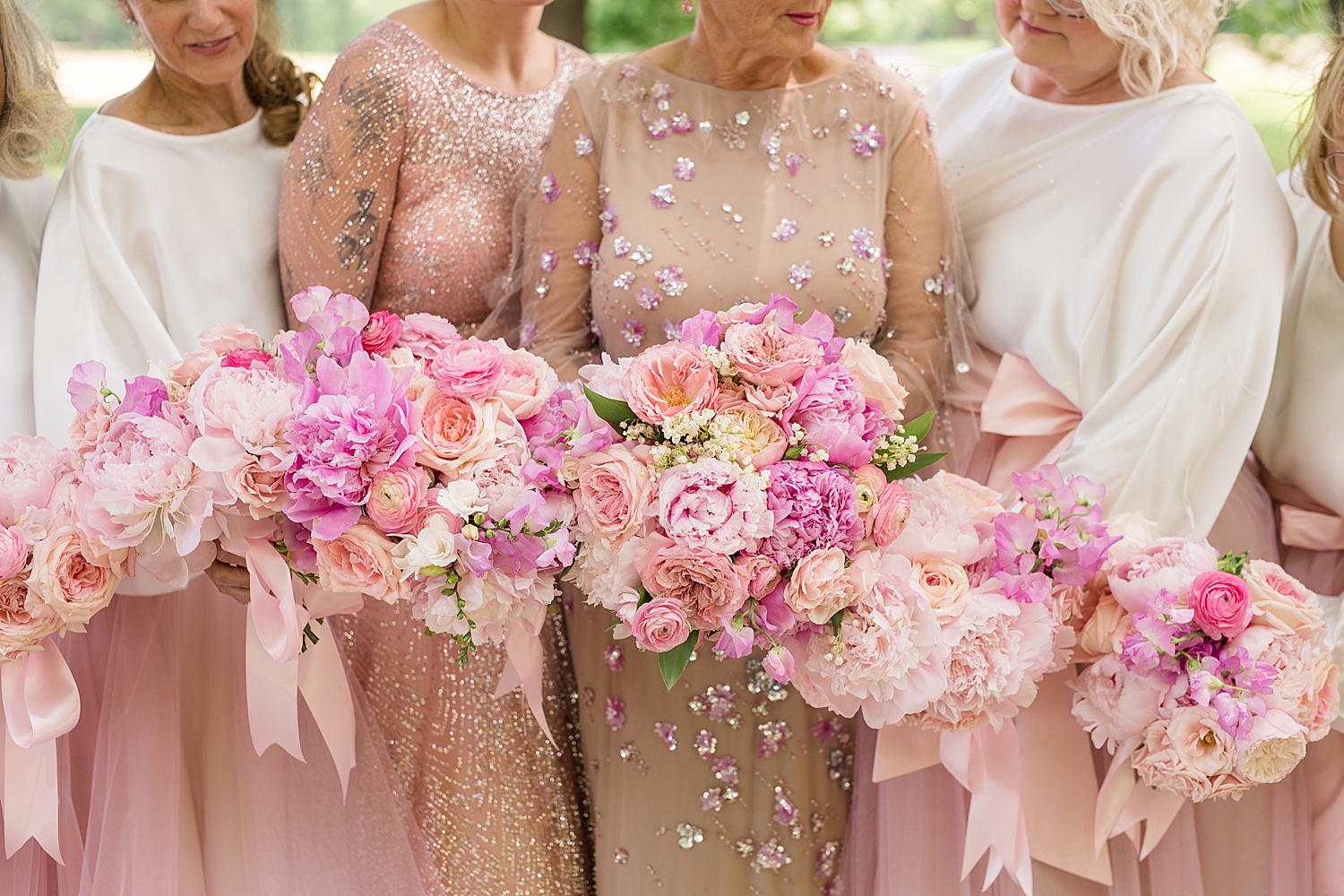 bridesmaids and bride in pink gowns with big pink bouquets