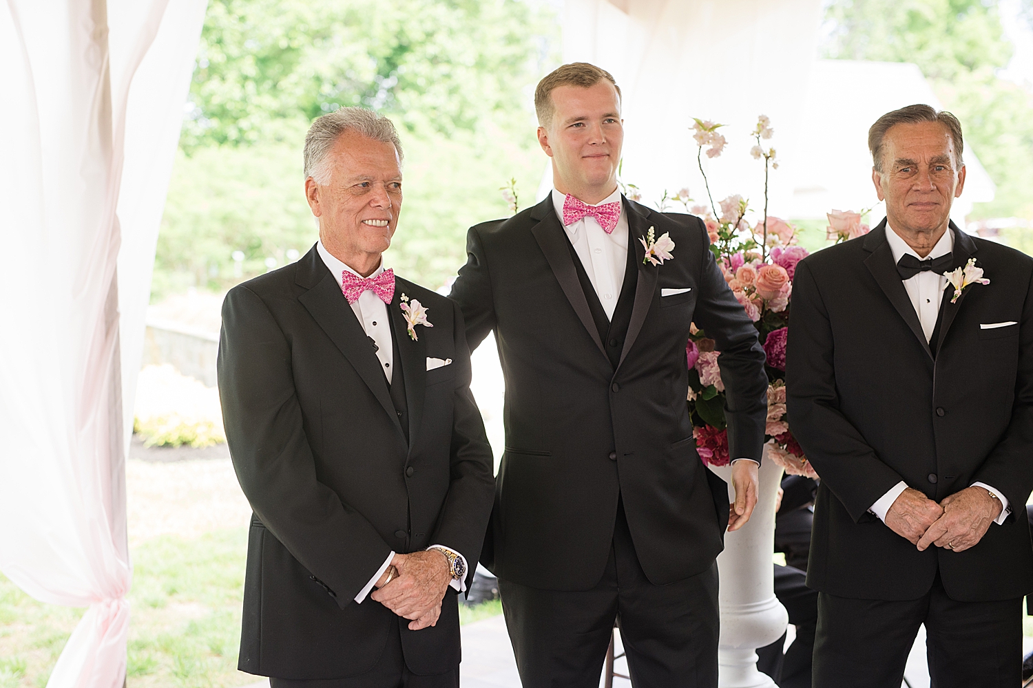 groom waits at the end of the aisle with son