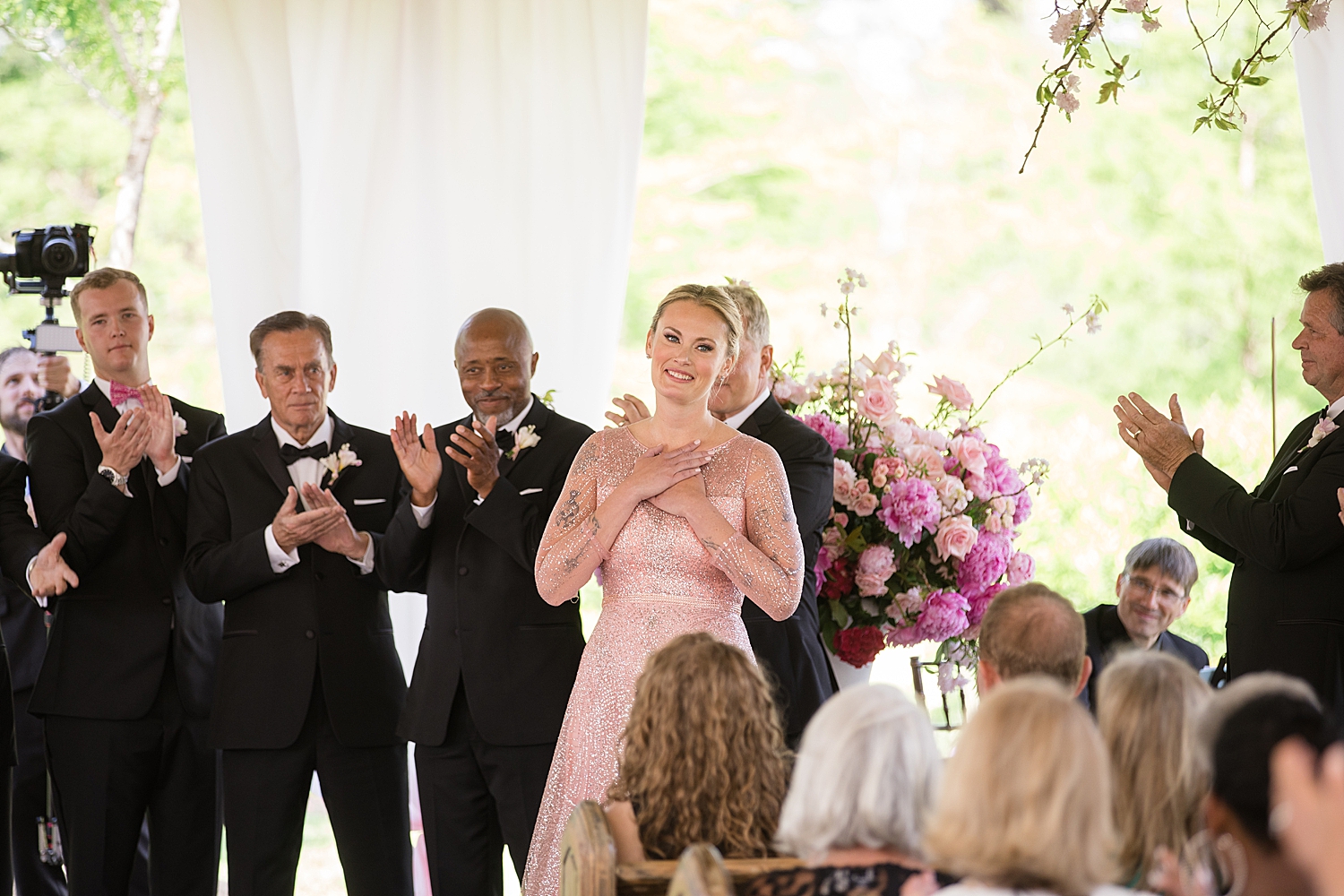 performer smiles as guests applaud