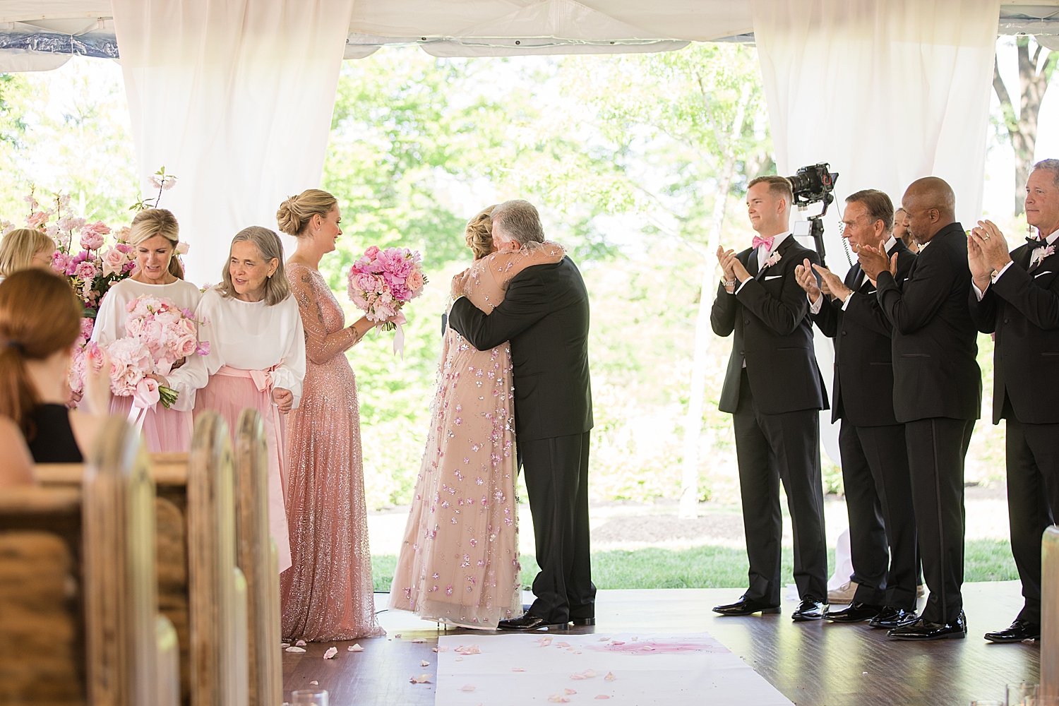 bride and groom embrace at the altar