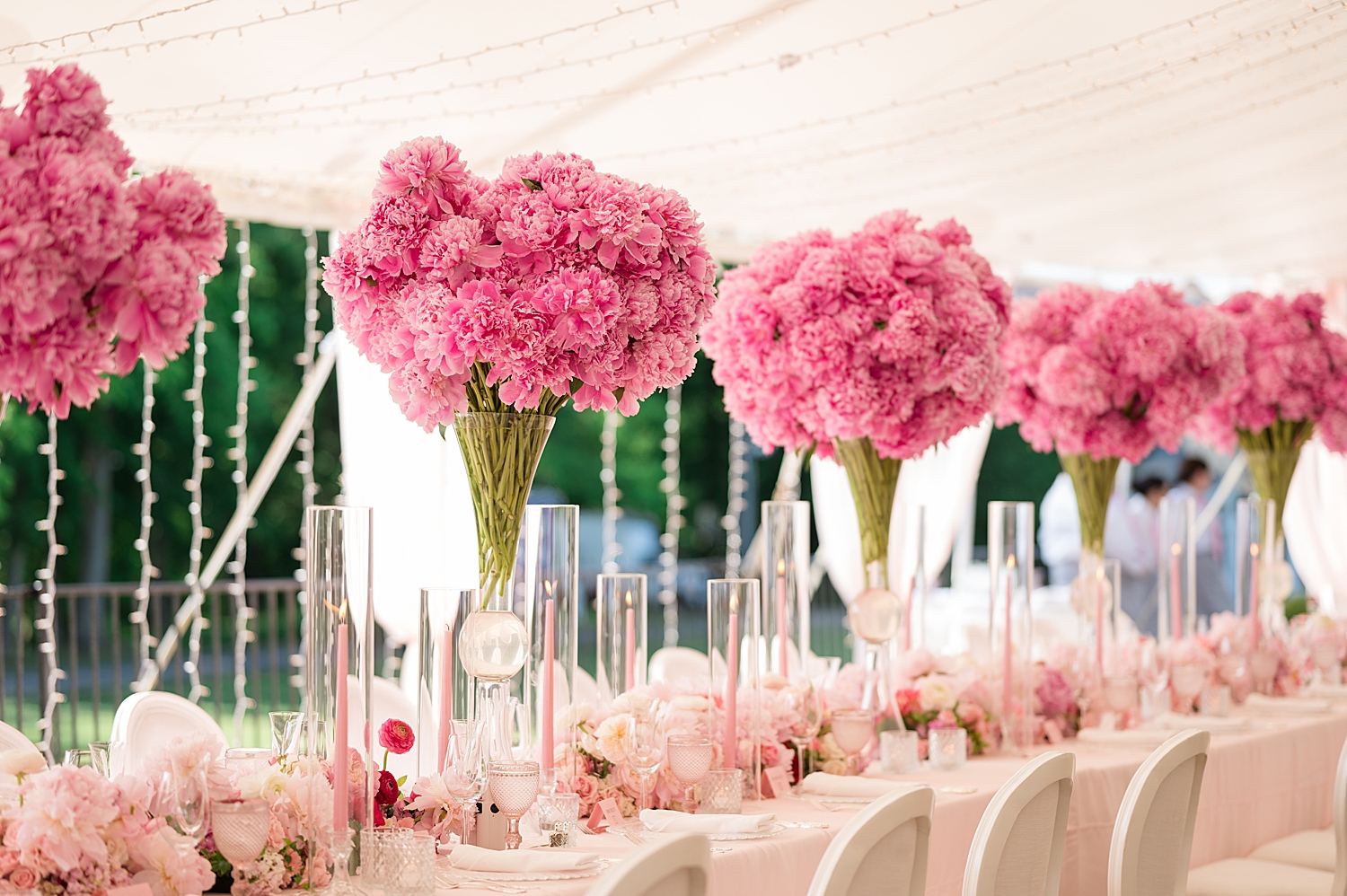 all pink details in tented reception, pink centerpieces