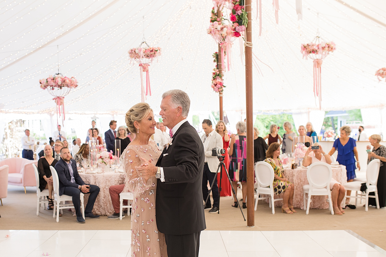 couple share first dance under reception tent