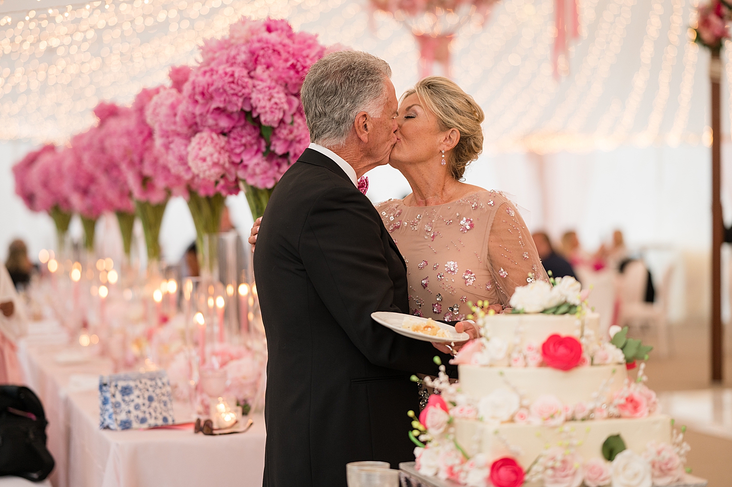 bride and groom kiss after cake cutting