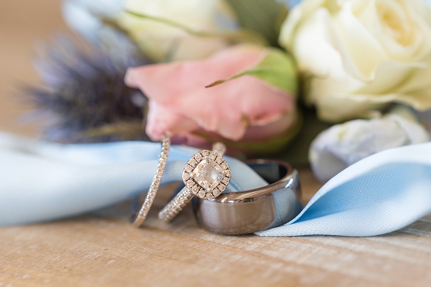 wedding rings stacked on blue ribbon