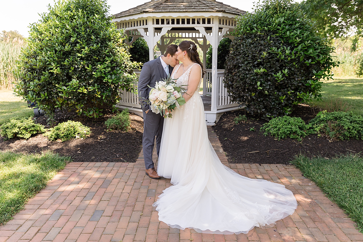 groom kisses bride's shoulder