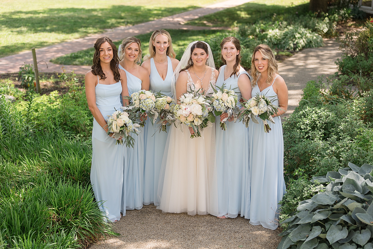 bride with bridesmaids in light blue dresses