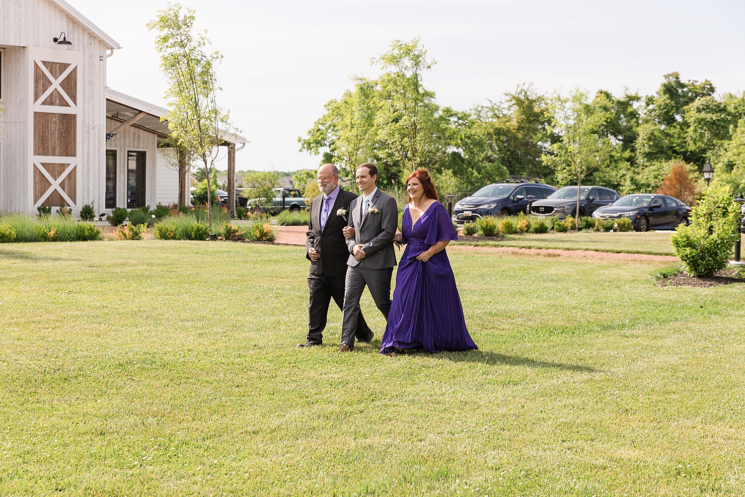 groom walking with parents down the aisle