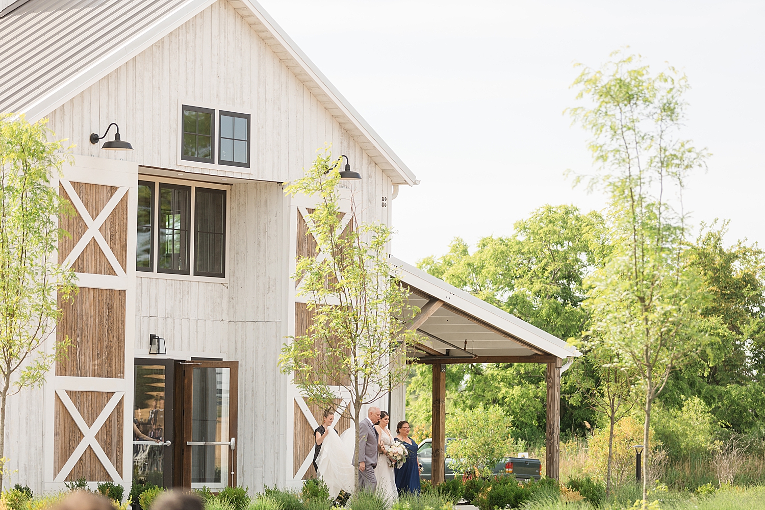 wide shot of bride approaching ceremony aisle