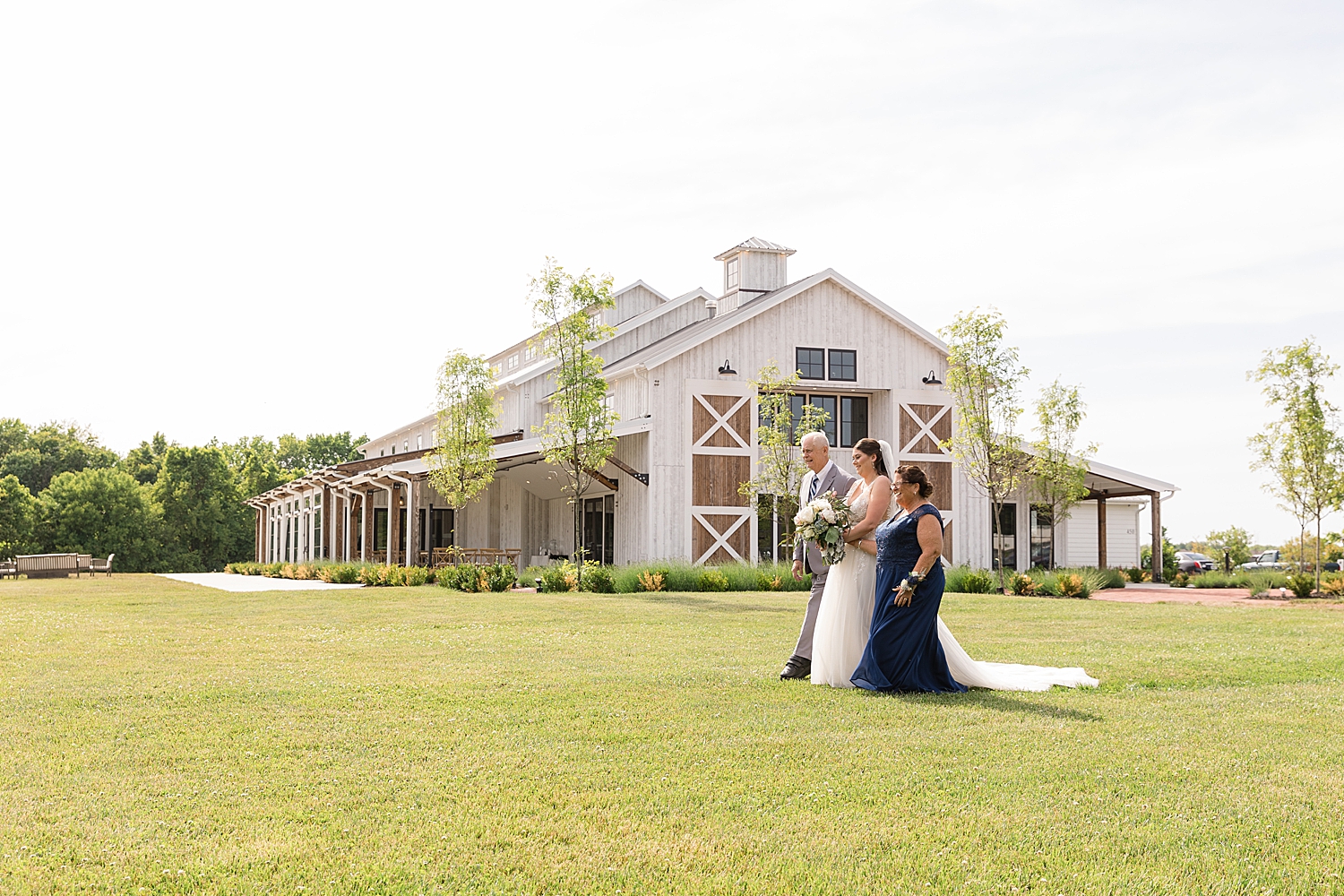 wide shot of bride approaching ceremony aisle