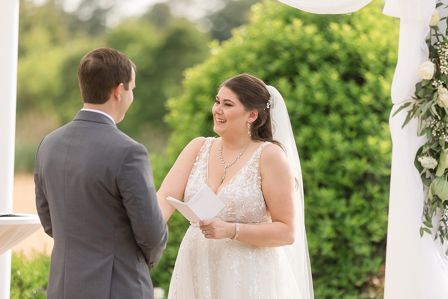 bride smiling while reading vows