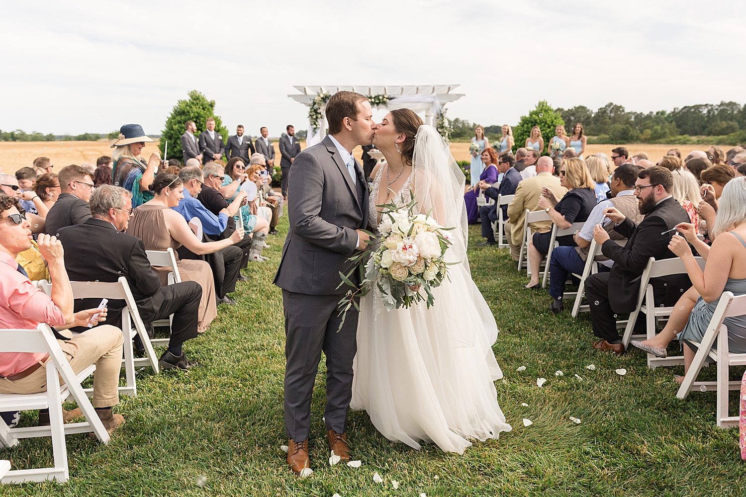 bride and groom recess down the aisle, kiss