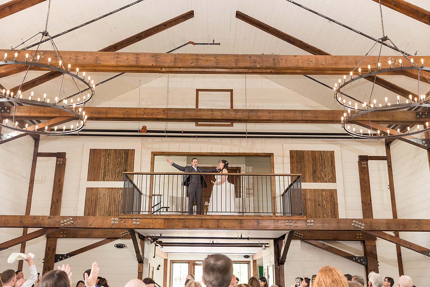 bride and groom enter reception from balcony