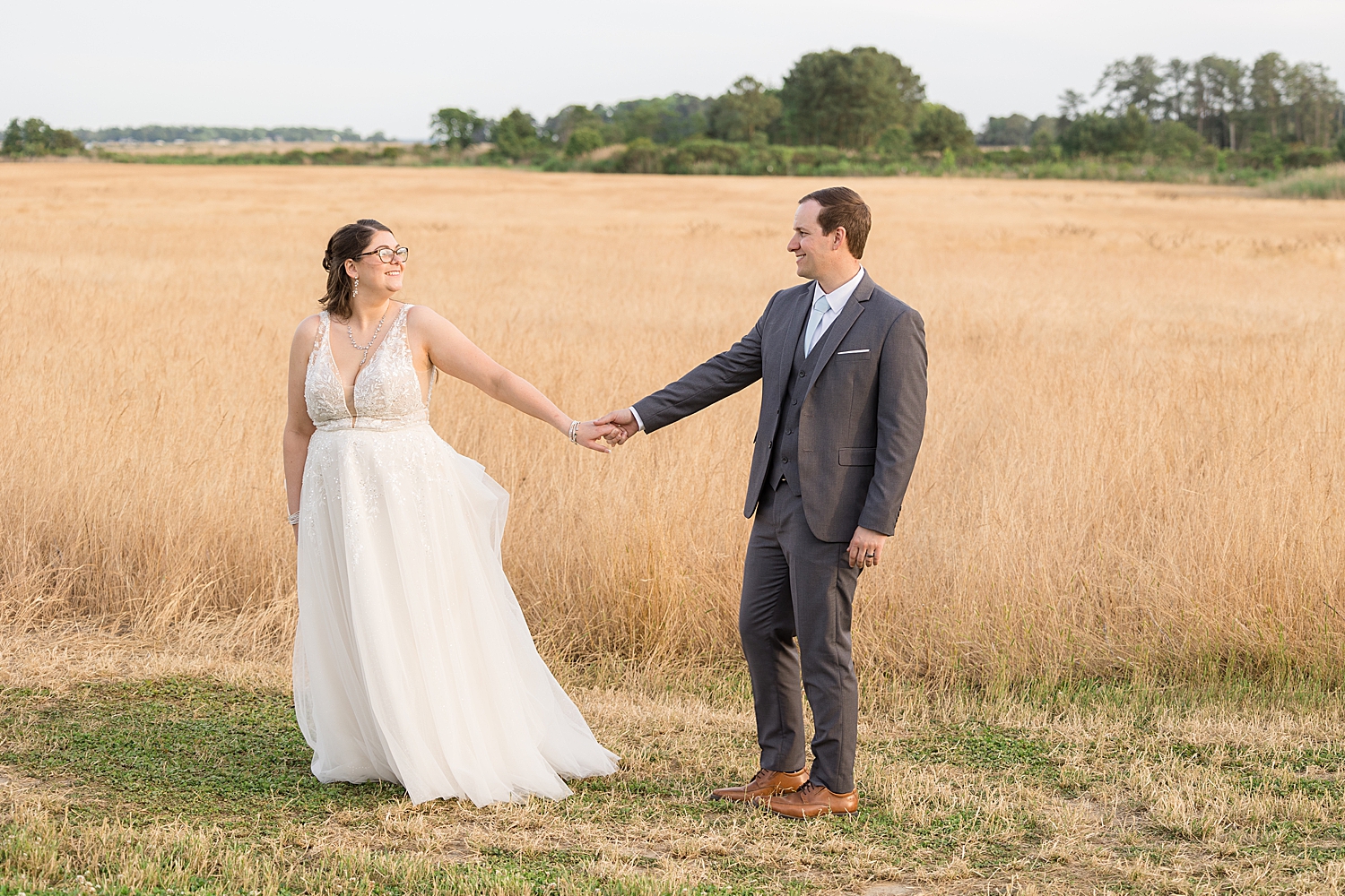 bride and groom sunset portrait in wheat