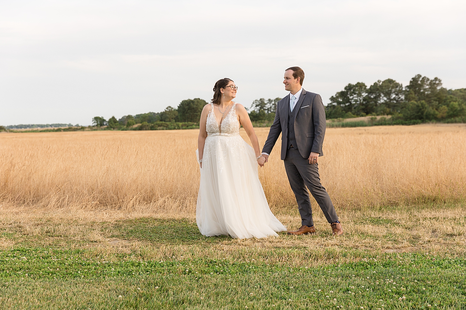 bride and groom sunset portrait in wheat