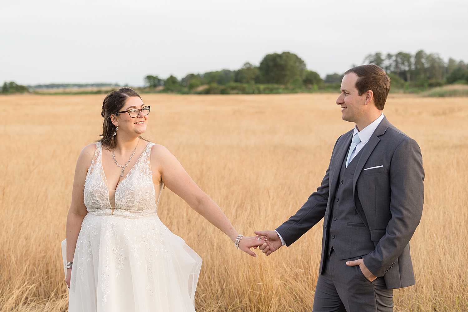 bride and groom sunset portrait in wheat