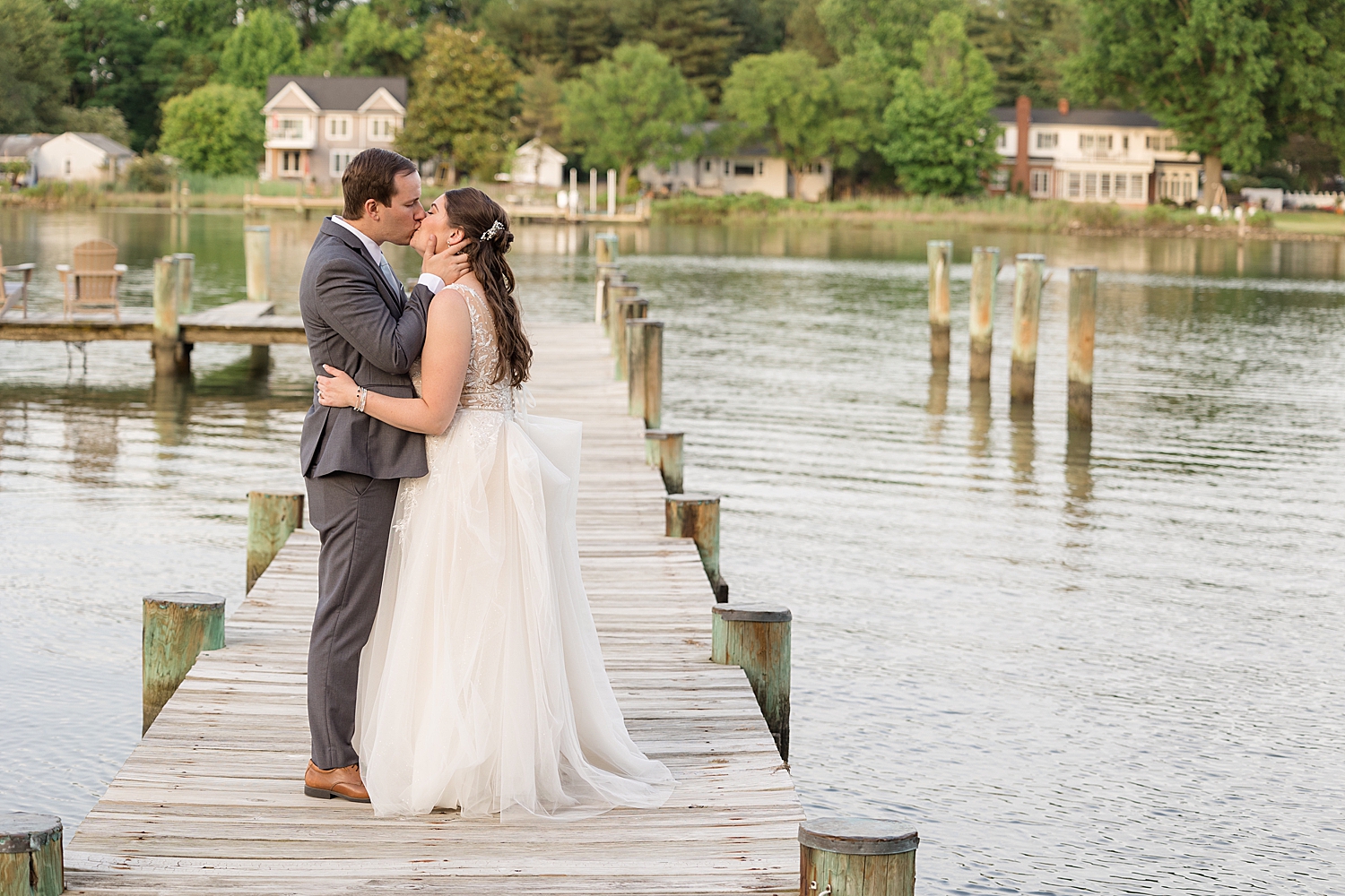 bride and groom kiss portrait on pier, chesapeake bay