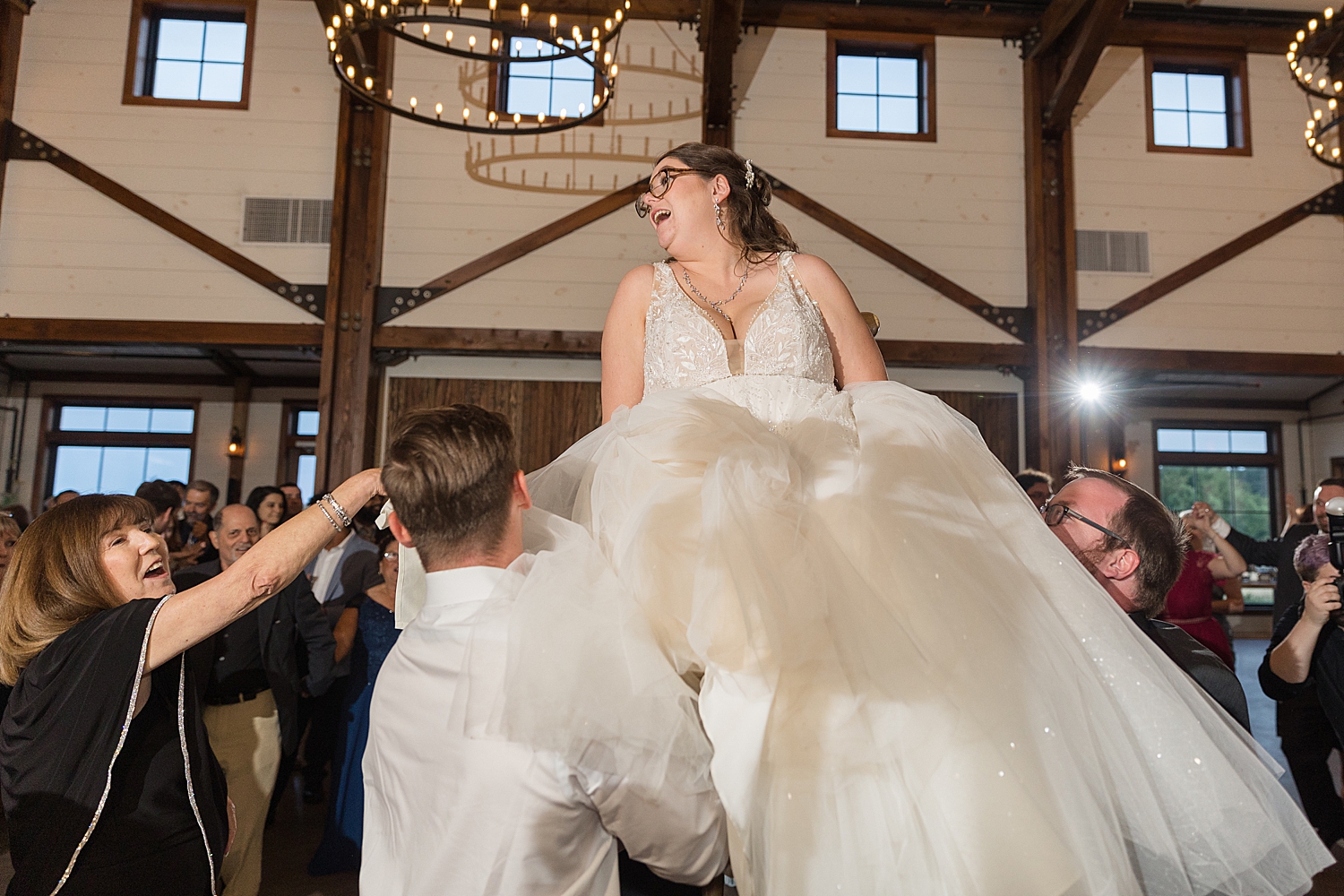 bride lifted in chair on dance floor