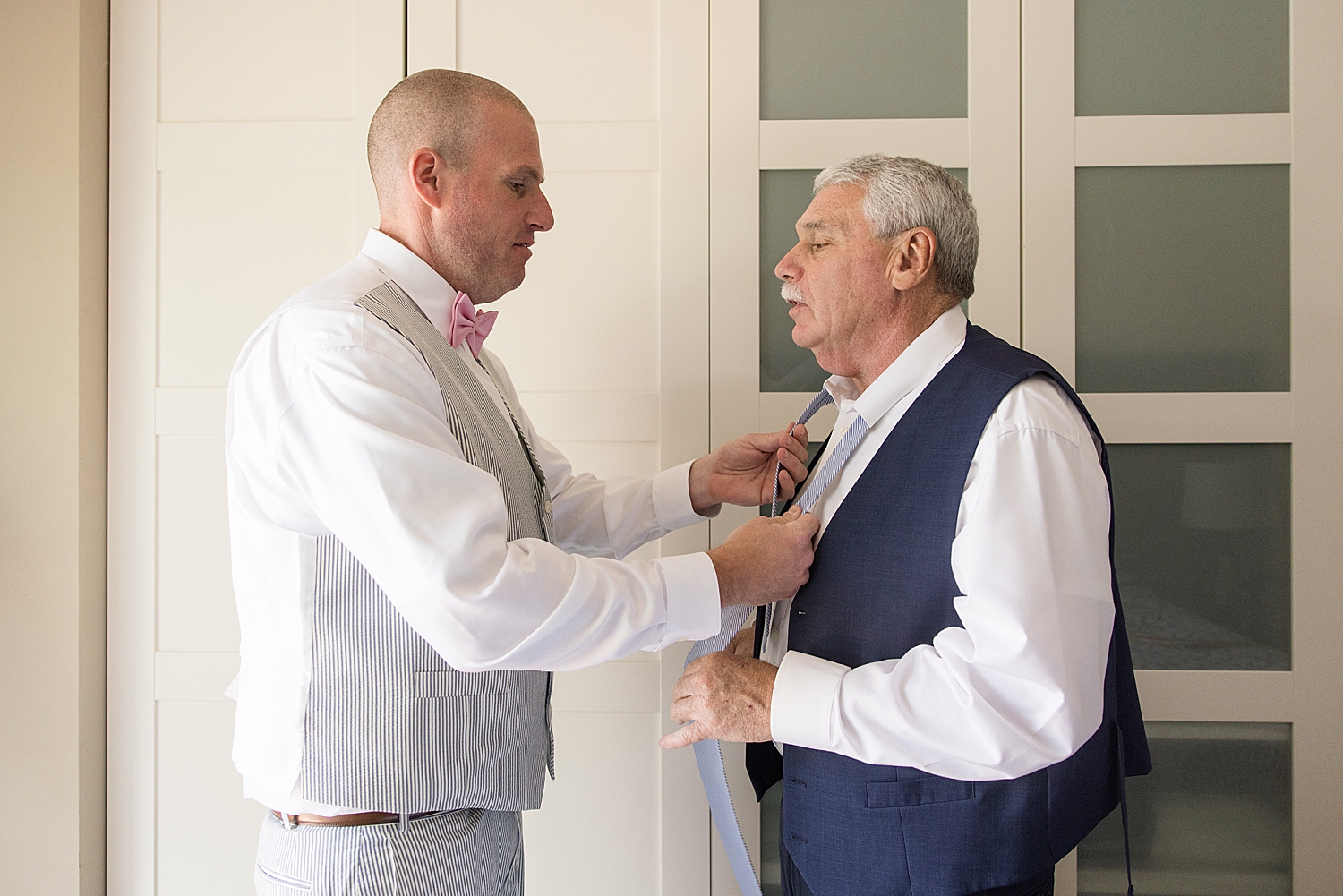 groom helps his dad get dressed