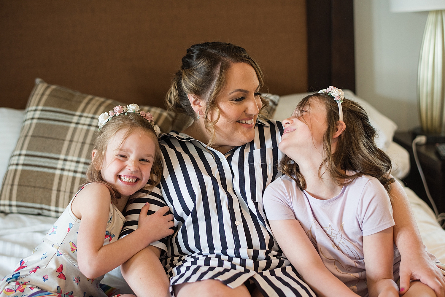 bride smiling with flower girls